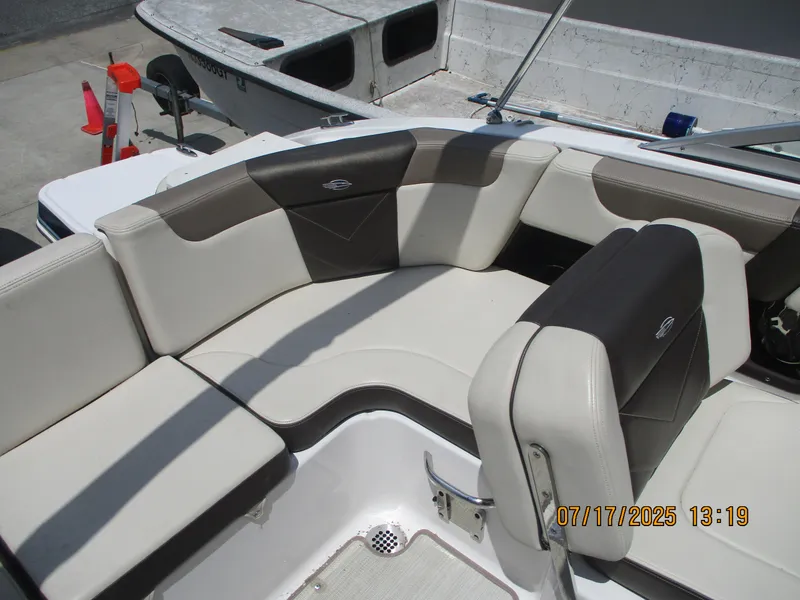 Slide: The Image of 2019 Chaparral 210 Suncoast boat interior with beige and black seating. - 17