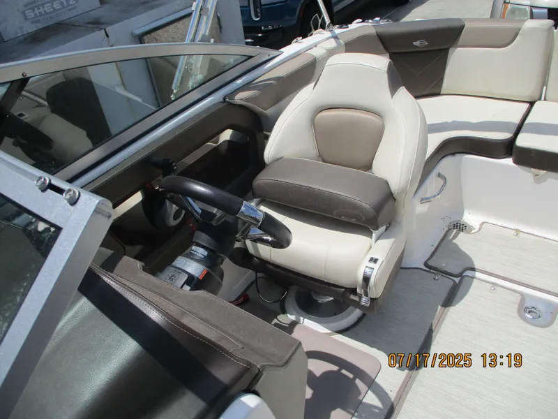 Slide: The Image of Interior of 2019 Chaparral 210 Suncoast boat with steering wheel and seating. - 19
