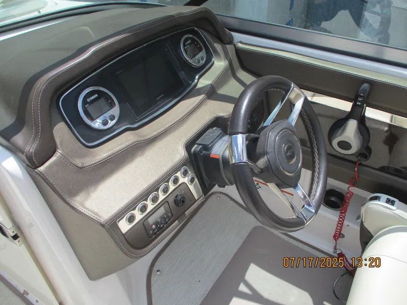 Slide: The Image of Dashboard of a 2019 Chaparral 210 Suncoast boat with steering wheel and controls. - 22