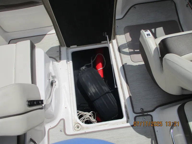 Slide: The Image of 2019 Chaparral 210 Suncoast boat storage compartment with equipment inside. - 25