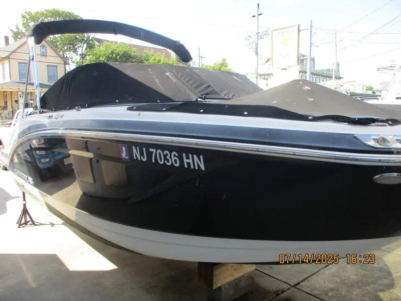 Slide: The Image of 2019 Chaparral 210 Suncoast boat with cover, parked outdoors, registration NJ 7036 HN. - 4