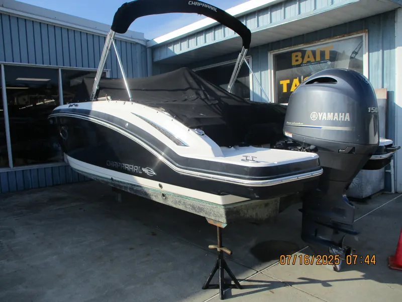 Slide: The Image of 2019 Chaparral 210 Suncoast boat with Yamaha engine, docked outside a bait shop. - 6