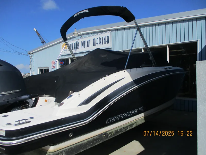 Slide: The Image of 2019 Chaparral 210 Suncoast boat at marina, covered and docked. - 8