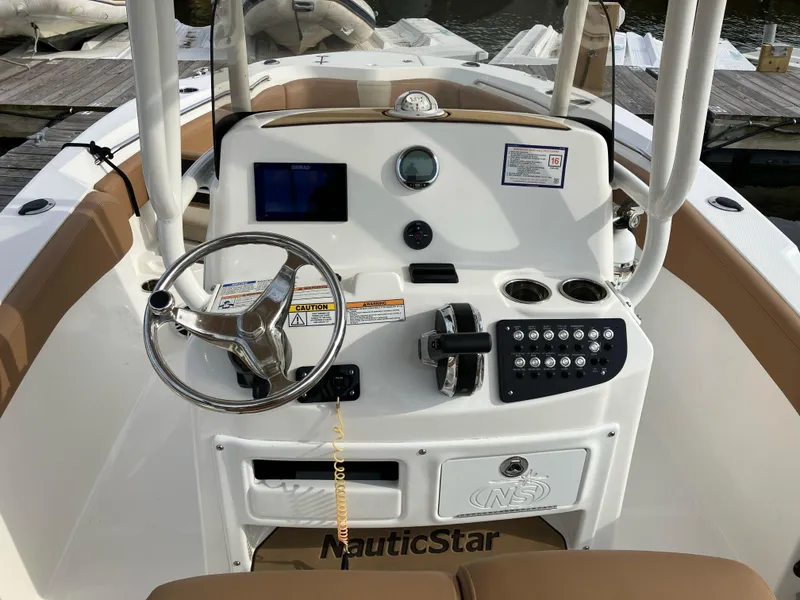 Slide: The Image of 2023 NauticStar 22L boat dashboard with steering wheel and control panel. - 4