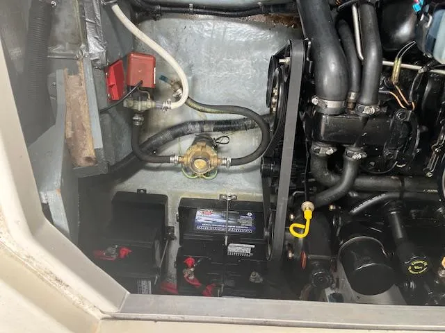 Slide: The Image of Engine compartment of a 1998 Sea Ray 290 Sundancer boat, showing batteries and mechanical components. - 19
