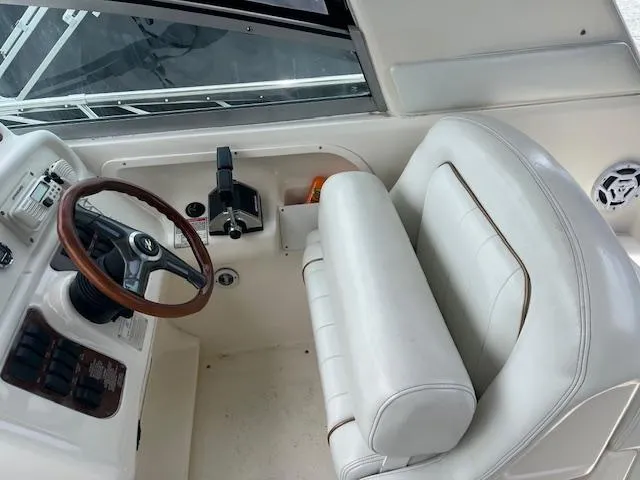 Slide: The Image of Cockpit of 1998 Sea Ray 290 Sundancer with steering wheel and control panel. - 6