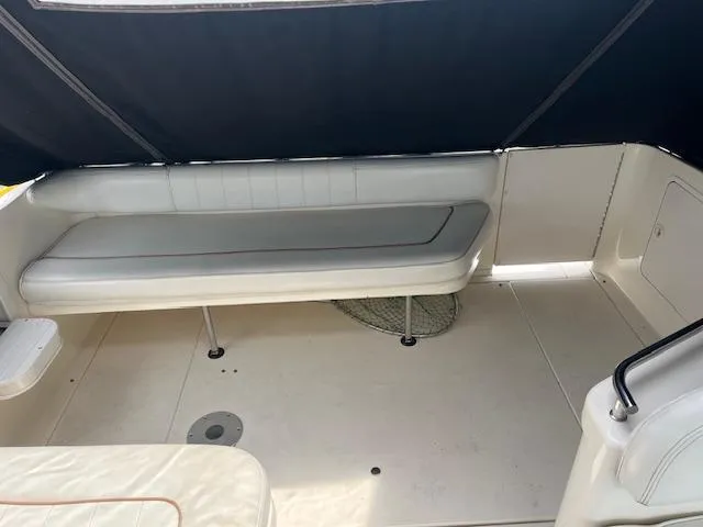 Slide: The Image of 1998 Sea Ray 290 Sundancer boat interior with white seating and canopy. - 9