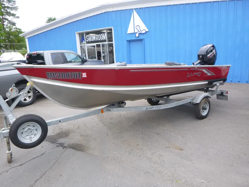 Slide: The Image of 2022 Lund SSV-16 boat on trailer outside blue showroom. - 4