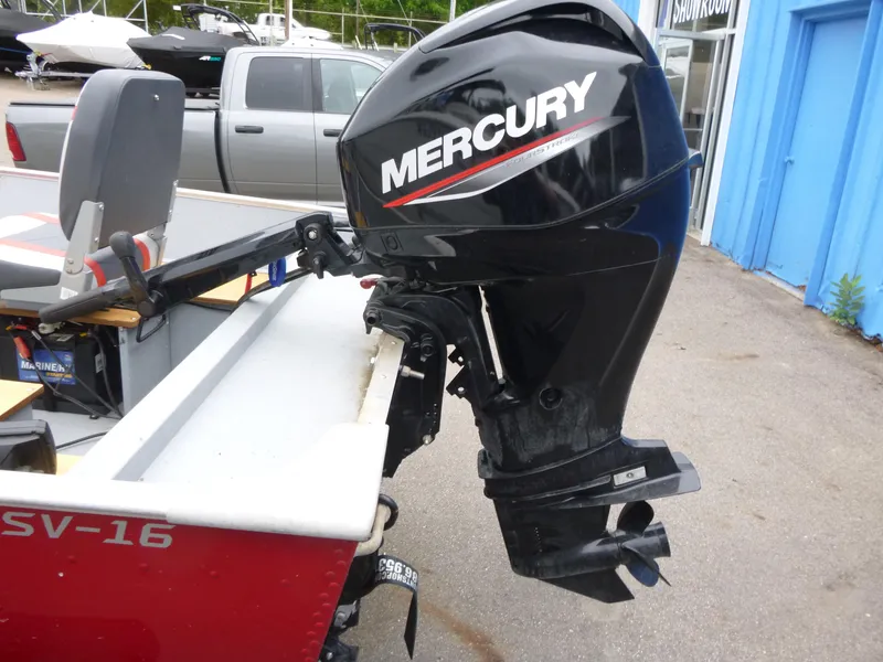 Slide: The Image of 2022 Lund SSV-16 boat with Mercury outboard motor in a showroom setting. - 8