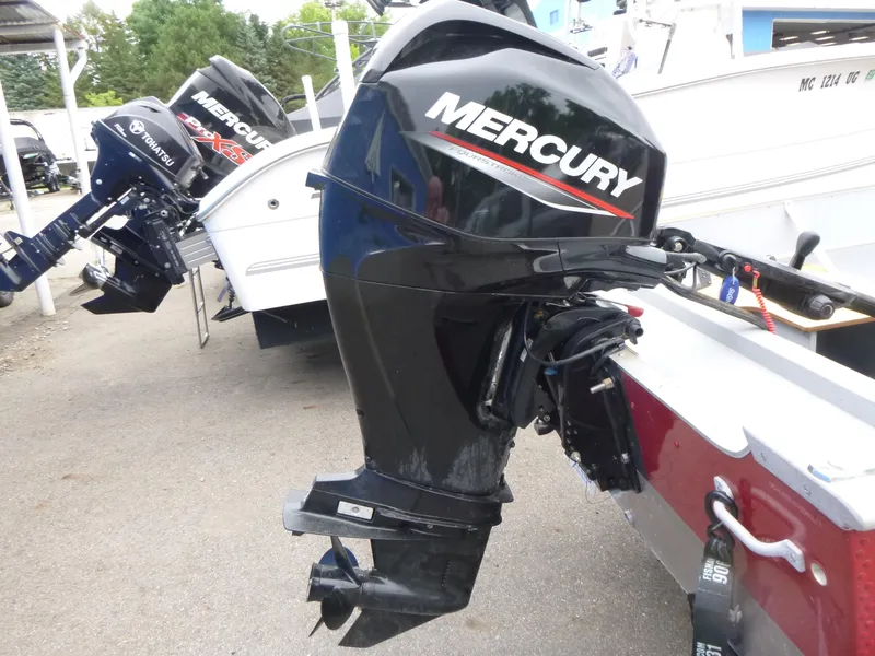 Slide: The Image of 2022 Lund SSV-16 boat with Mercury outboard motor in a marina setting. - 9