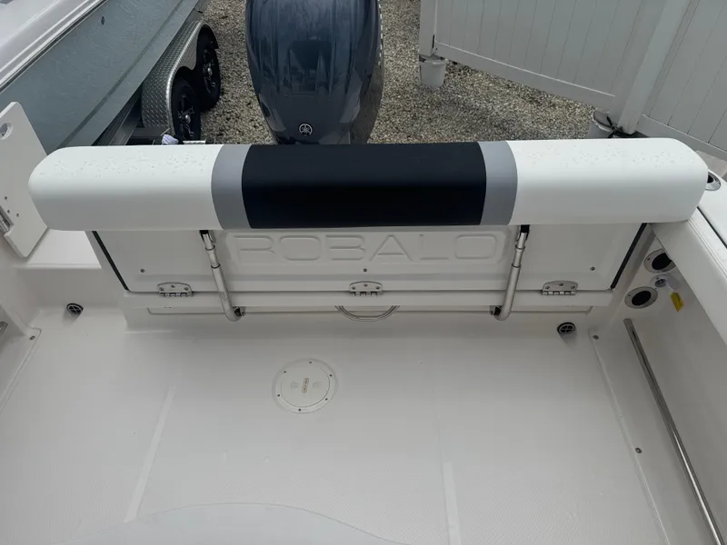 Slide: The Image of 2025 Robalo R222 Center Console boat interior with seating and engine view. - 13