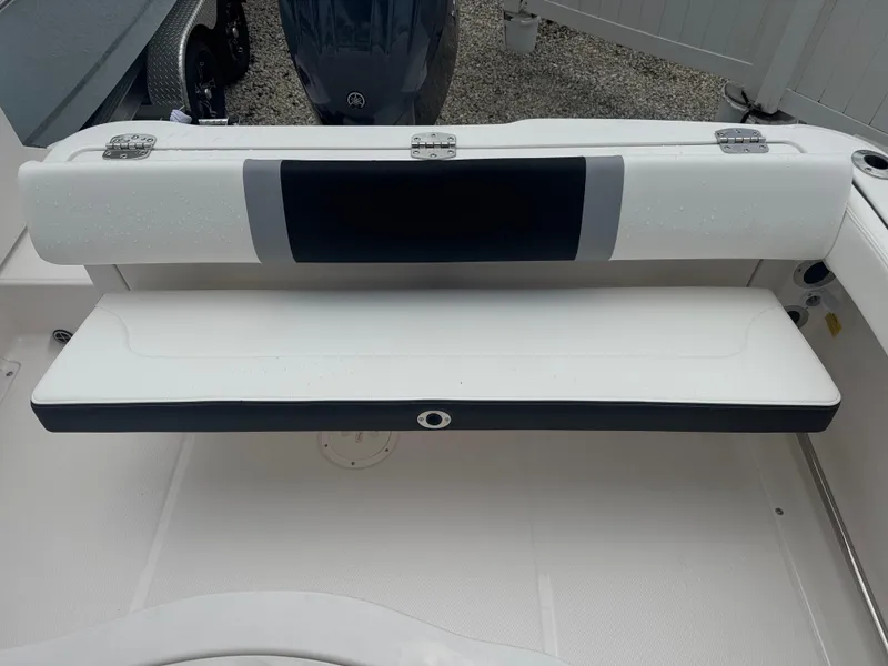 Slide: The Image of 2025 Robalo R222 Center Console boat seat, white and black, with foldable design. - 14