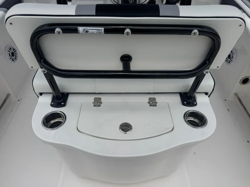 Slide: The Image of 2025 Robalo R222 Center Console boat seat with cup holders and storage compartment. - 17