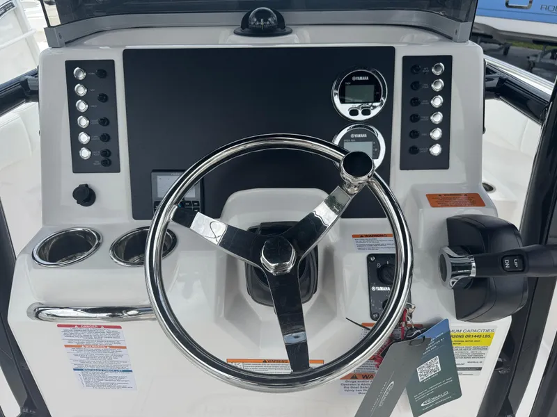 Slide: The Image of 2025 Robalo R222 Center Console dashboard with steering wheel and control panel. - 5