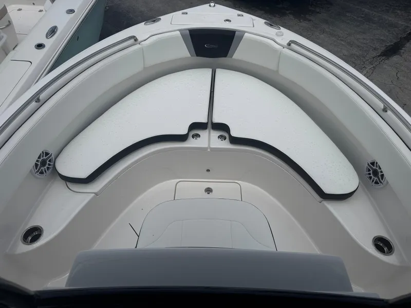 Slide: The Image of 2025 Robalo R222 Center Console boat interior with cushioned seating and cup holders. - 6