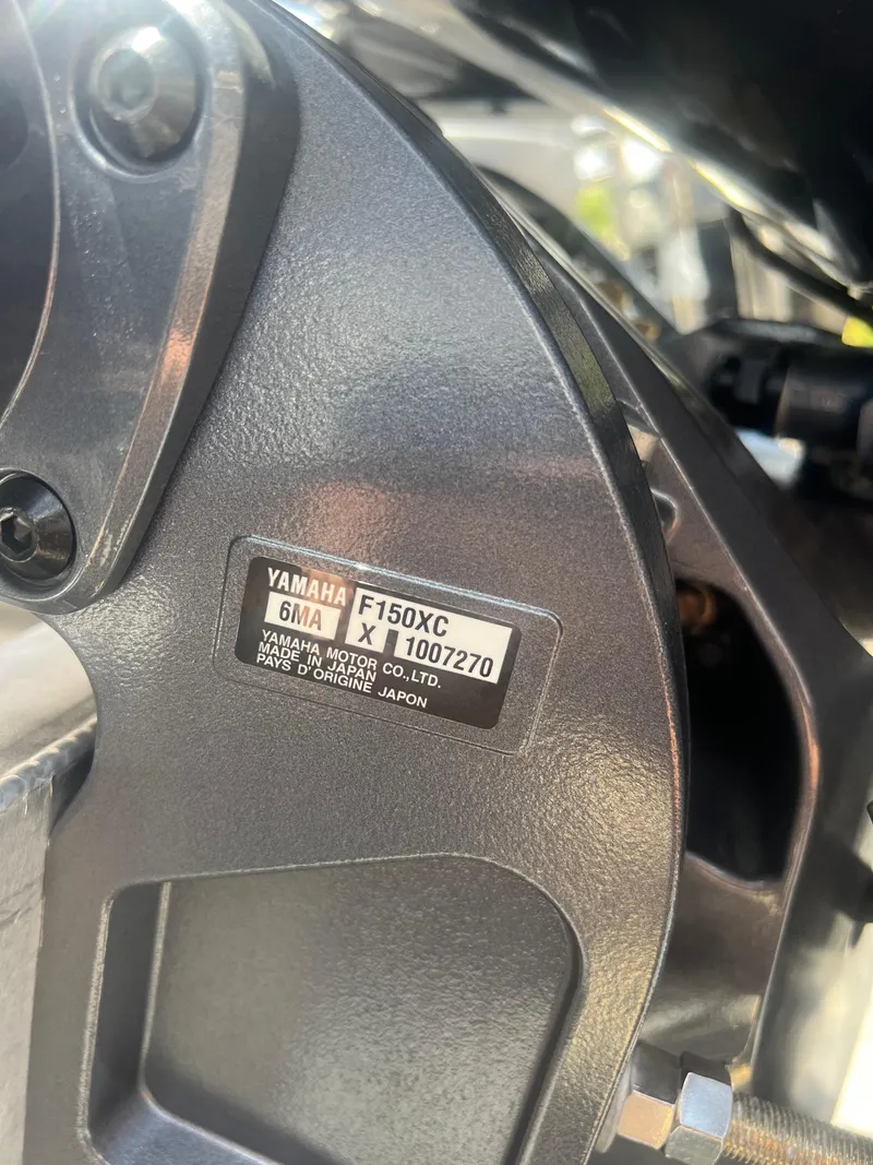 Slide: The Image of Close-up of Yamaha F150XC engine label on 2022 Godfrey Monaco 235 SDB boat. - 13