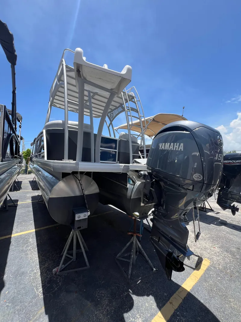 Slide: The Image of 2022 Godfrey Monaco 235 SDB pontoon boat with Yamaha outboard motor, parked on stands. - 14