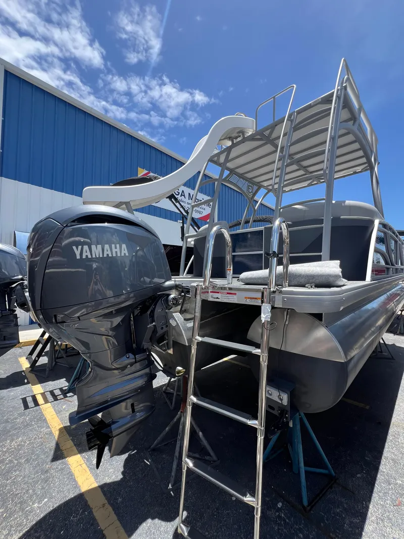 Slide: The Image of 2022 Godfrey Monaco 235 SDB pontoon boat with Yamaha outboard motor and slide, parked outdoors. - 17