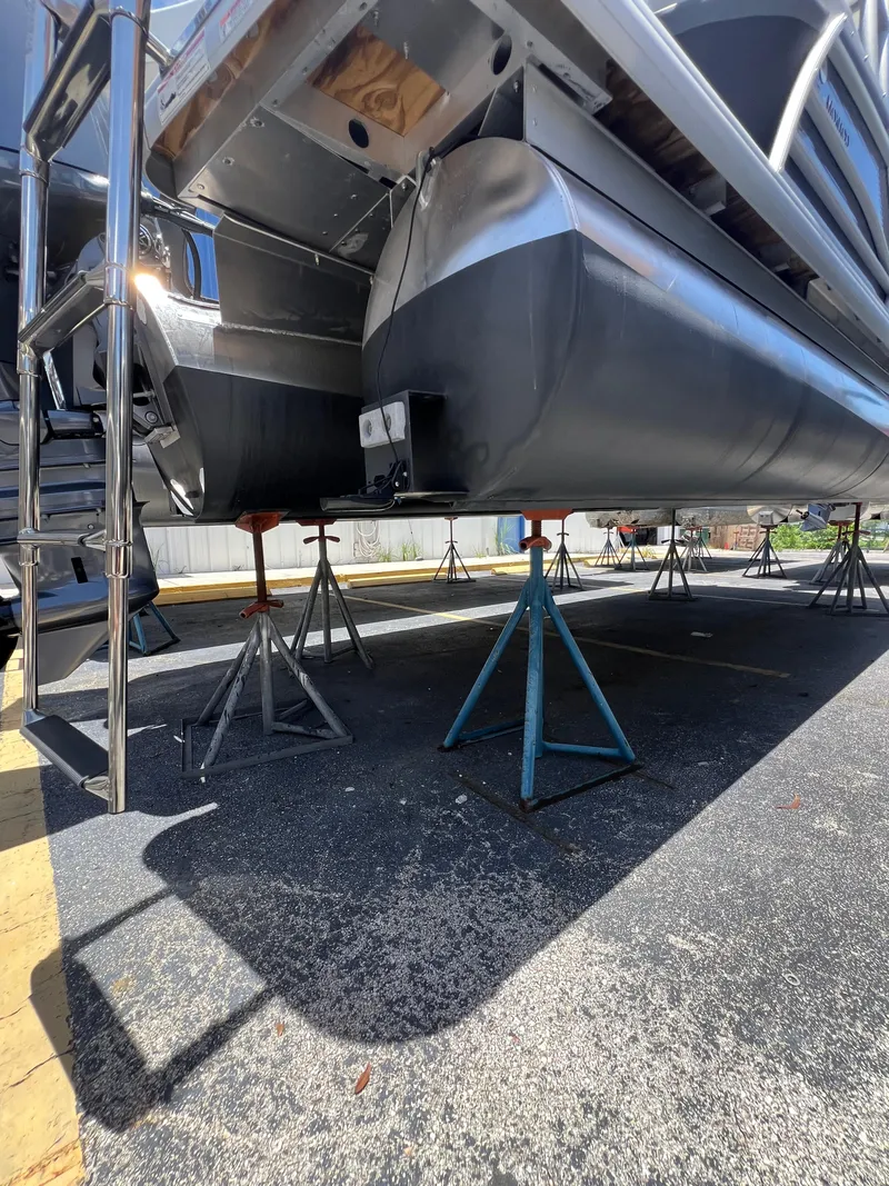 Slide: The Image of 2022 Godfrey Monaco 235 SDB pontoon boat on stands, underside view. - 18