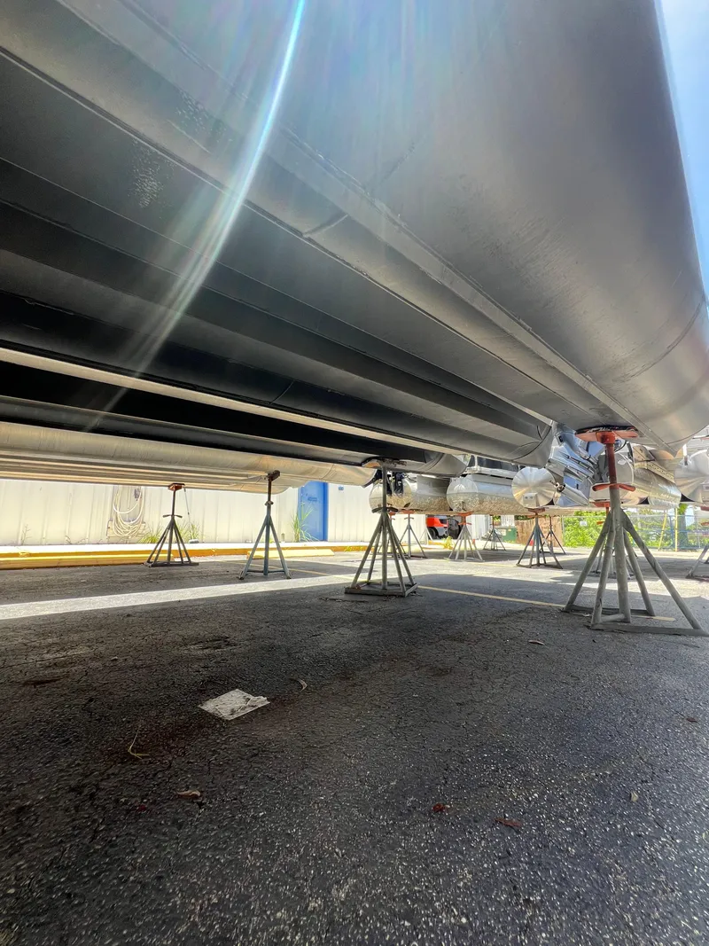 Slide: The Image of Underneath view of a 2022 Godfrey Monaco 235 SDB boat on stands. - 21