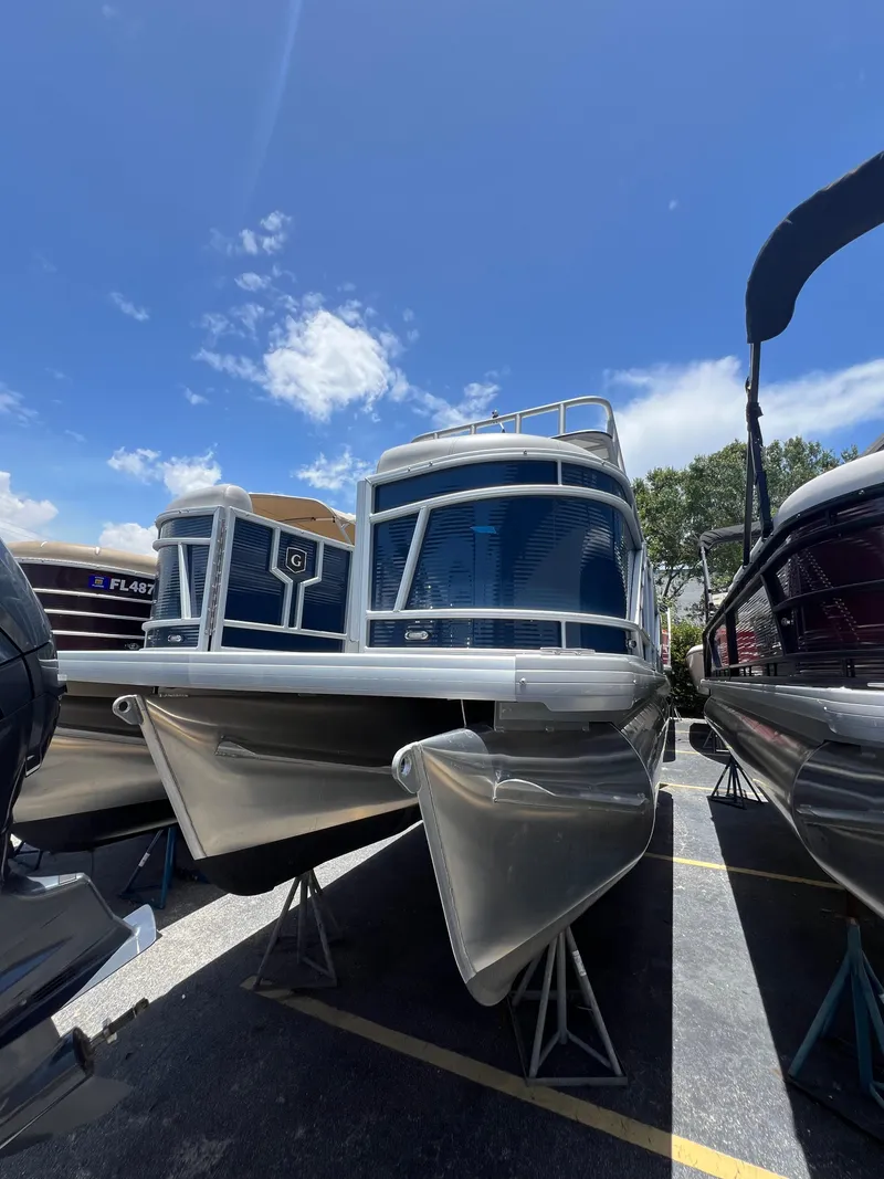 Slide: The Image of 2022 Godfrey Monaco 235 SDB pontoon boat displayed under a clear blue sky. - 24