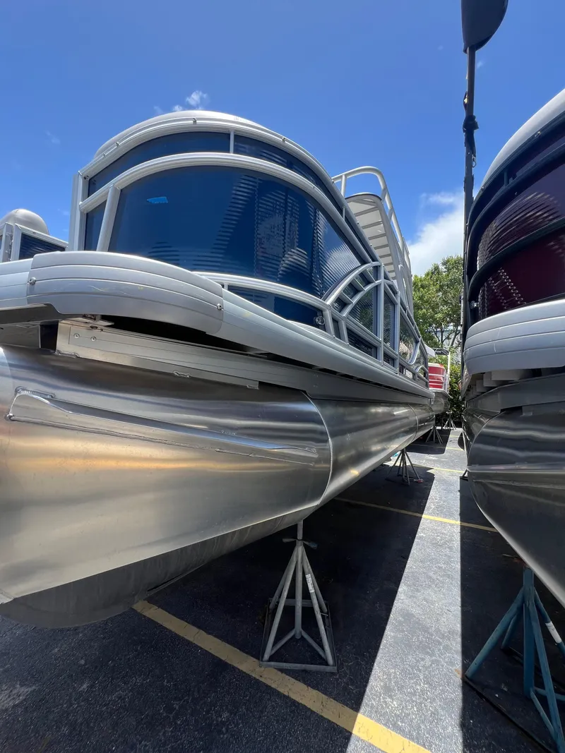 Slide: The Image of 2022 Godfrey Monaco 235 SDB pontoon boat displayed outdoors on stands. - 25