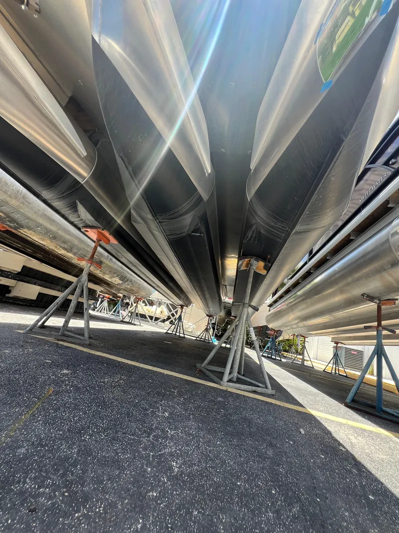 Slide: The Image of Underneath view of a 2022 Godfrey Monaco 235 SDB boat on stands. - 26