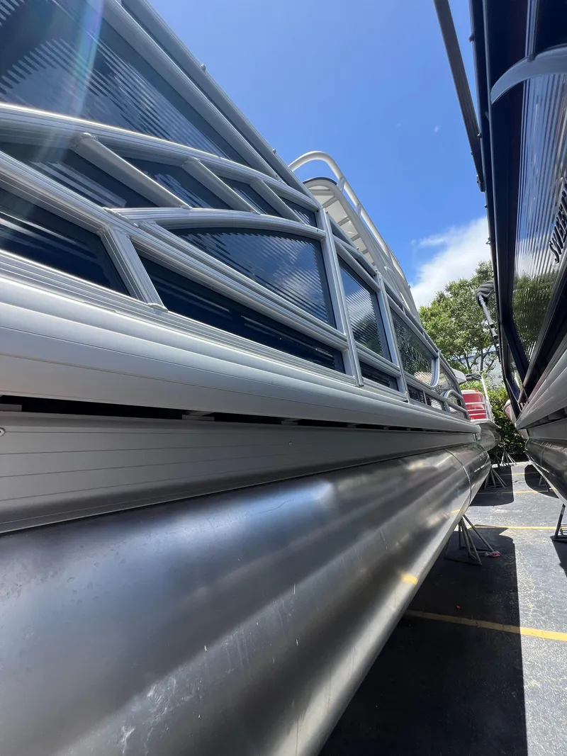 Slide: The Image of 2022 Godfrey Monaco 235 SDB pontoon boat, side view under clear blue sky. - 27