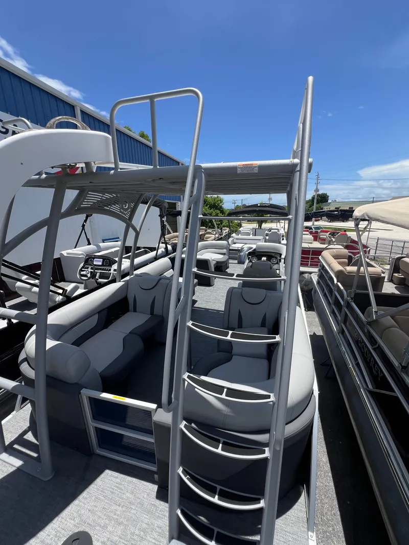 Slide: The Image of 2022 Godfrey Monaco 235 SDB pontoon boat with slide, parked outdoors under clear blue sky. - 30