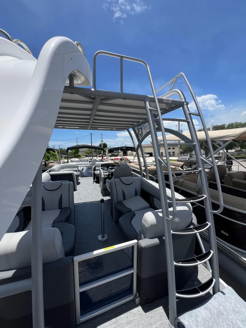 Slide: The Image of 2022 Godfrey Monaco 235 SDB pontoon boat with upper deck and slide under clear blue sky. - 32