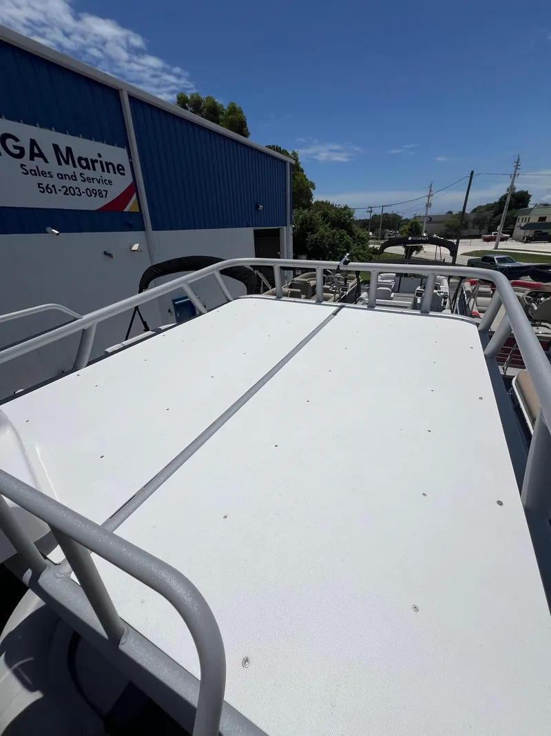 Slide: The Image of 2022 Godfrey Monaco 235 SDB boat deck at marina, clear sky background. - 33