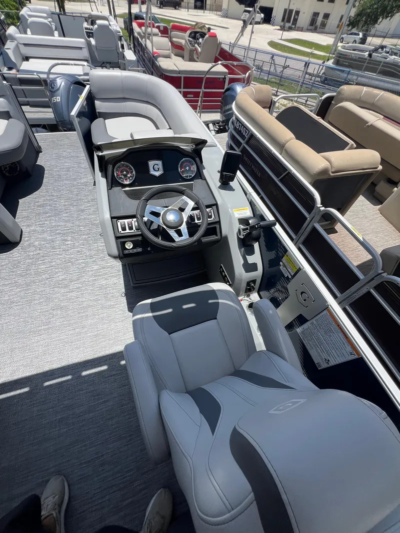 Slide: The Image of 2022 Godfrey Monaco 235 SDB boat interior with steering console and seating. - 4