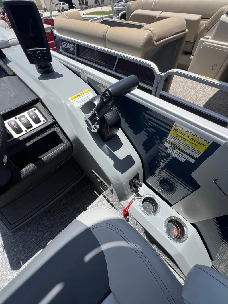 Slide: The Image of 2022 Godfrey Monaco 235 SDB boat interior with control panel and seating. - 6
