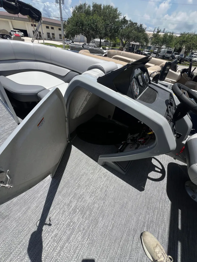 Slide: The Image of 2022 Godfrey Monaco 235 SDB boat interior with open storage compartment and seating area. - 7