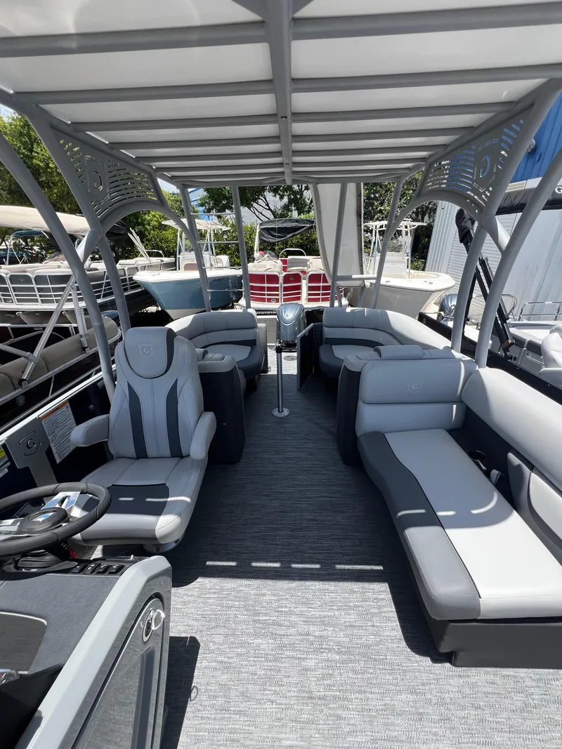 Slide: The Image of 2022 Godfrey Monaco 235 SDB pontoon boat interior with gray seating and canopy. - 9