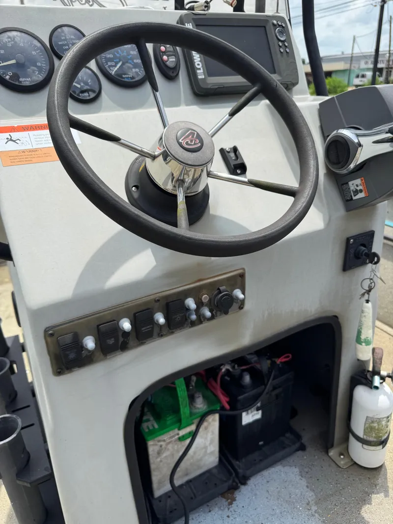 Slide: The Image of 2018 Alumacraft 1860 Bay boat console with steering wheel and control panel. - 11