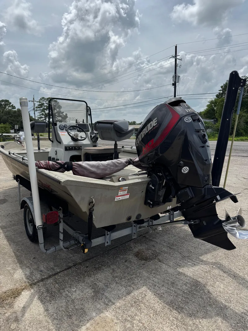Slide: The Image of 2018 Alumacraft 1860 Bay boat with Evinrude motor on trailer, parked outdoors. - 3