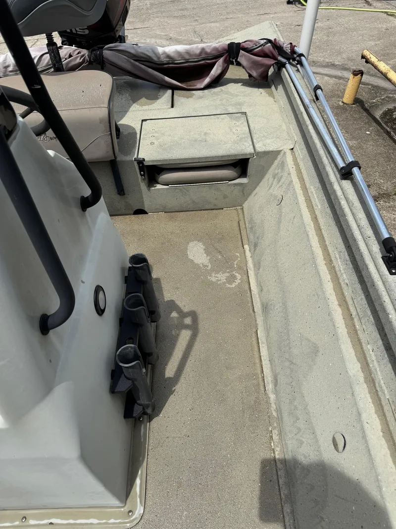 Slide: The Image of 2018 Alumacraft 1860 Bay boat interior with seating and storage compartments. - 9