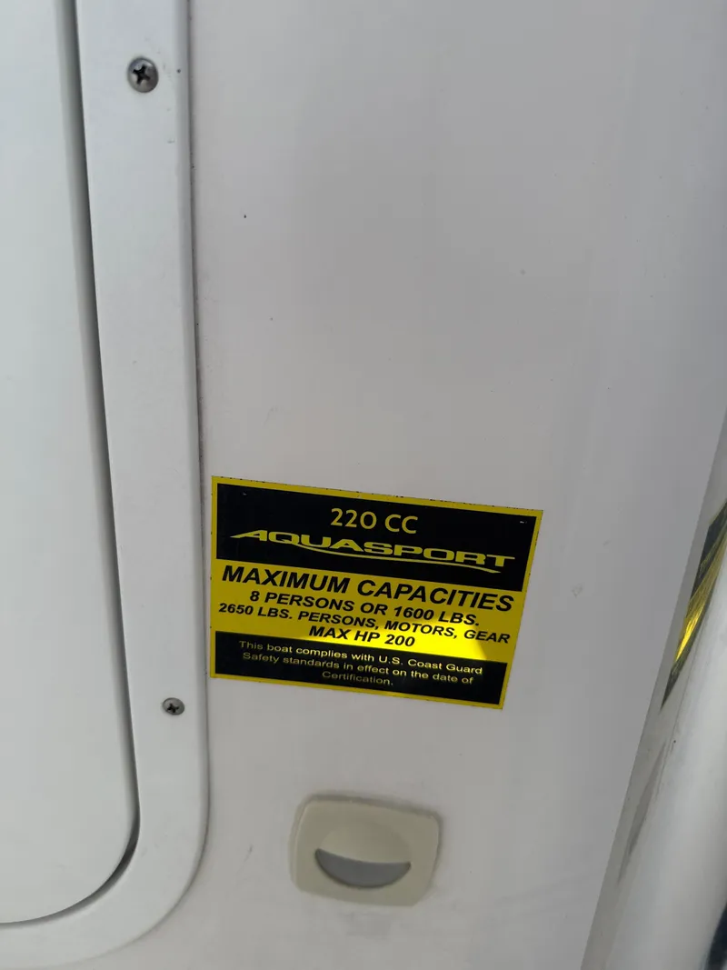 Slide: The Image of 2024 Aquasport 2200 Center Console capacity label, 8 persons, 1600 lbs, max HP 200. - 3