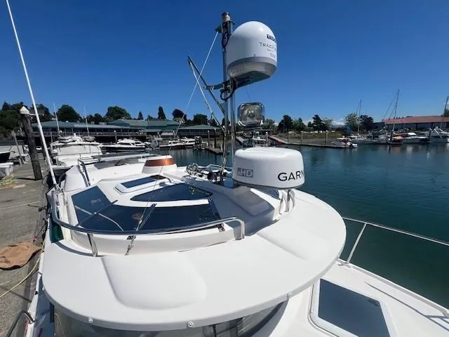 Slide: The Image of 2022 Ranger Tugs R-29 S boat docked at marina under clear blue sky. - 13