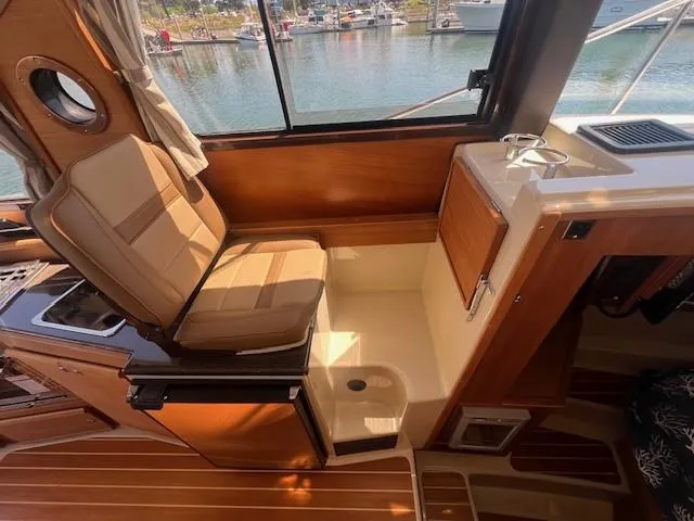 Slide: The Image of Interior of 2022 Ranger Tugs R-29 S boat with seating and window view. - 7
