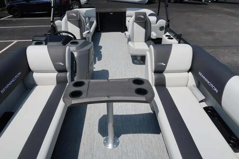 Slide: The Image of 2026 Bennington S Quad Bench 22 SSR pontoon boat interior with gray and white seating. - 10
