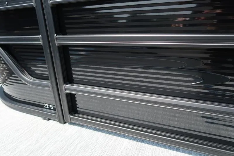 Slide: The Image of 2026 Bennington S Quad Bench 22 SSR, sleek black exterior detail. - 16