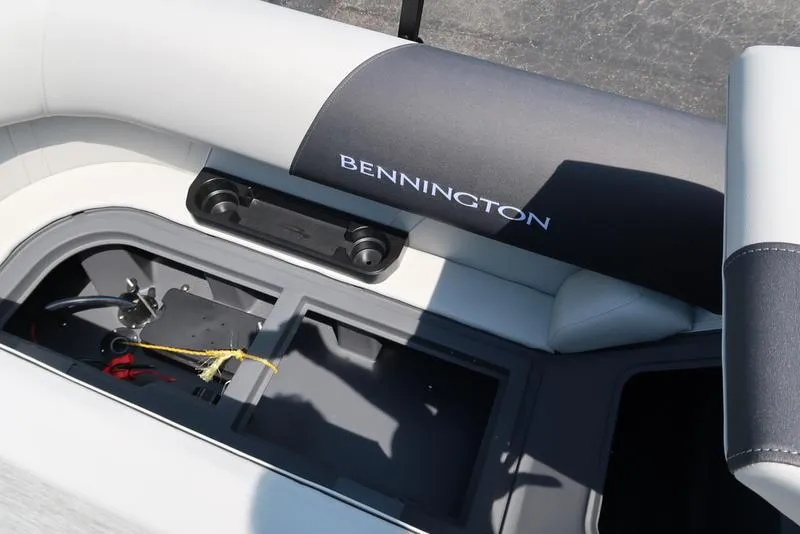 Slide: The Image of 2026 Bennington S Quad Bench 22 SSR boat seat with storage compartment open. - 26