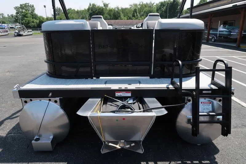 Slide: The Image of 2026 Bennington S Quad Bench 22 SSR pontoon boat, rear view in a parking lot. - 3