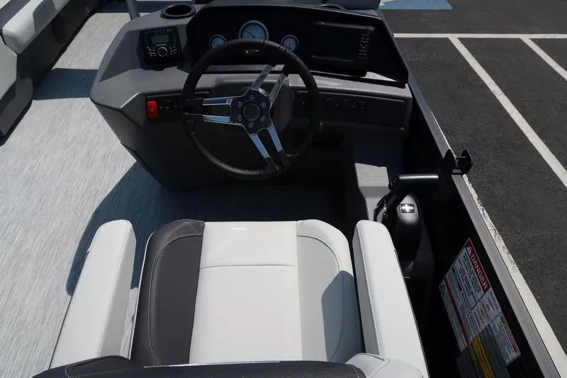 Slide: The Image of 2026 Bennington S Quad Bench 22 SSR boat cockpit with steering wheel and control panel. - 30