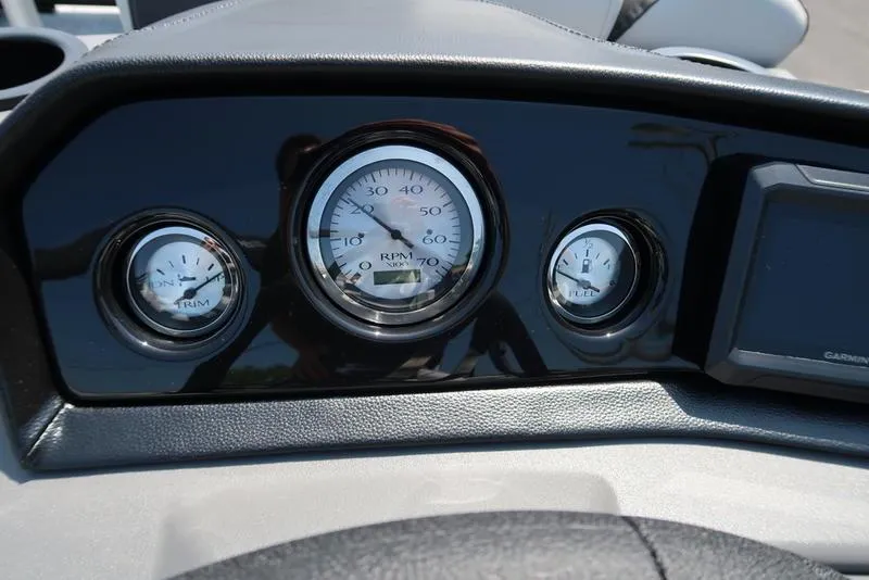 Slide: The Image of Dashboard of 2026 Bennington S Quad Bench 22 SSR with RPM, trim, and fuel gauges. - 31