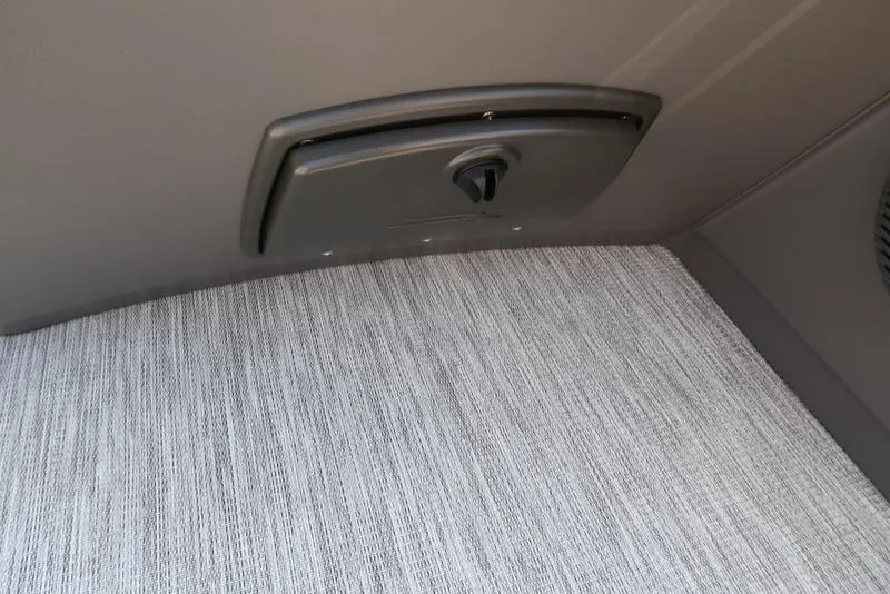 Slide: The Image of Interior detail of 2026 Bennington S Quad Bench 22 SSR boat, featuring a storage compartment. - 35