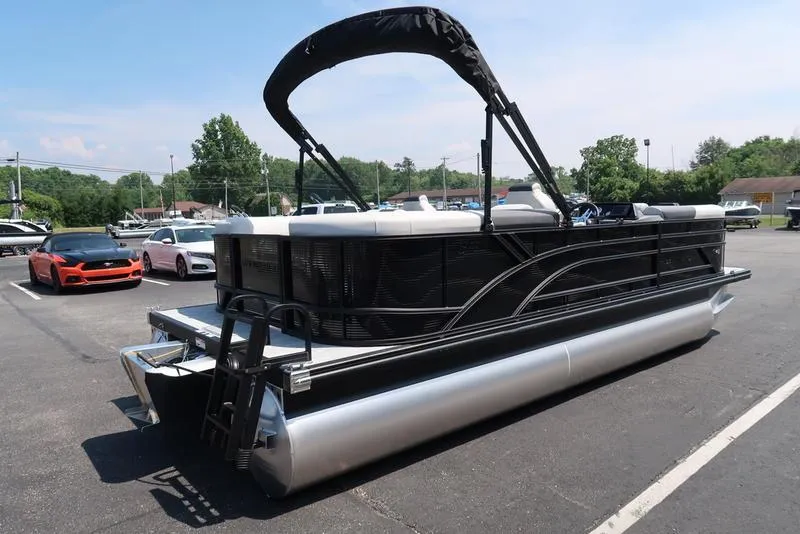 Slide: The Image of 2026 Bennington S Quad Bench 22 SSR pontoon boat in parking lot, side view. - 36