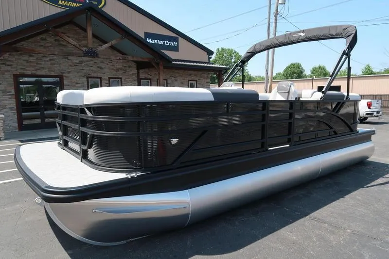 Slide: The Image of 2026 Bennington S Quad Bench 22 SSR pontoon boat parked outside dealership. - 5